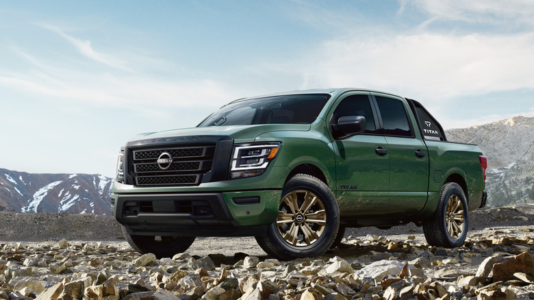 Green 2024 Nissan Titan parked on rocks