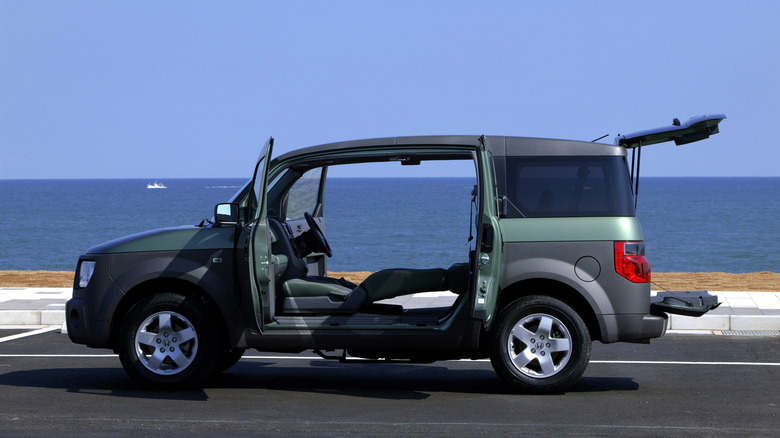 Honda Element with its rear-hinged doors and rear split tailgate open, side view, green exterior