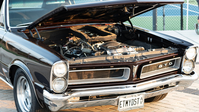 1965 Pontiac GTO with hood open, front-right view