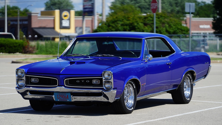 1966 Pontiac GTO in parking lot, front-left 3/4 view