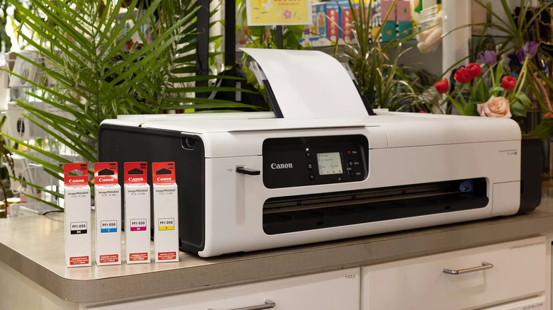 Canon printer with ink boxes in office
