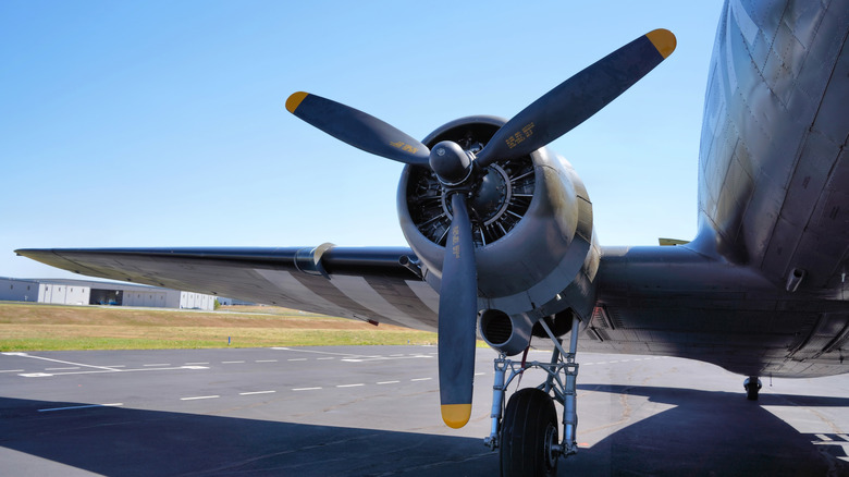 A Close Up of the Engine, Wing, and Propeller on an Old Transport Airplane