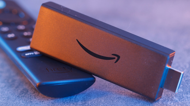 A Fire TV Stick next to its remote