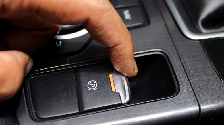 Driver's finger activating electric parking brake