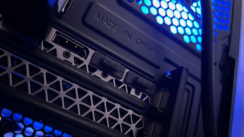 A close up of a graphics card I/O bracket on the back of a PC