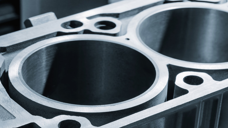 Close-up of disassembled engine block showing cylinders and sleeves