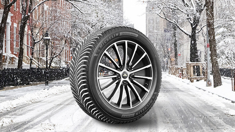 Michelin CrossClimate2 tire mounted on wheel sitting in center of snowy street scene