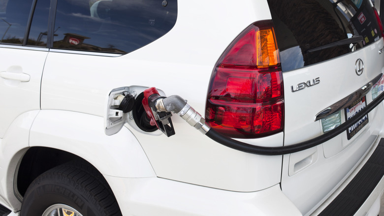 White Lexus car at gas pump