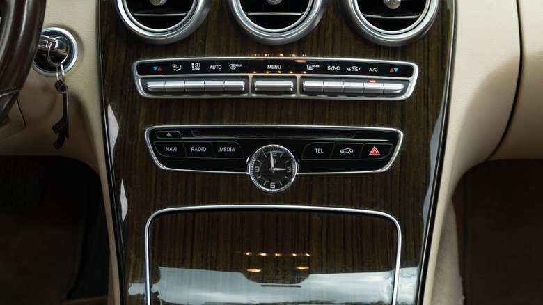Mercedes-Benz C180 wood trim center console with an analog clock