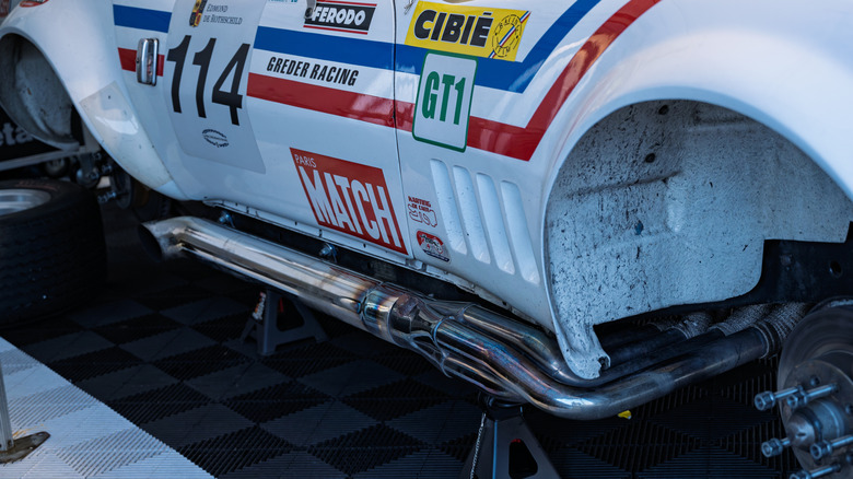1973 Chevrolet Corvette C3 race car with side-exit exhaust and wheels removed, right-side close-up