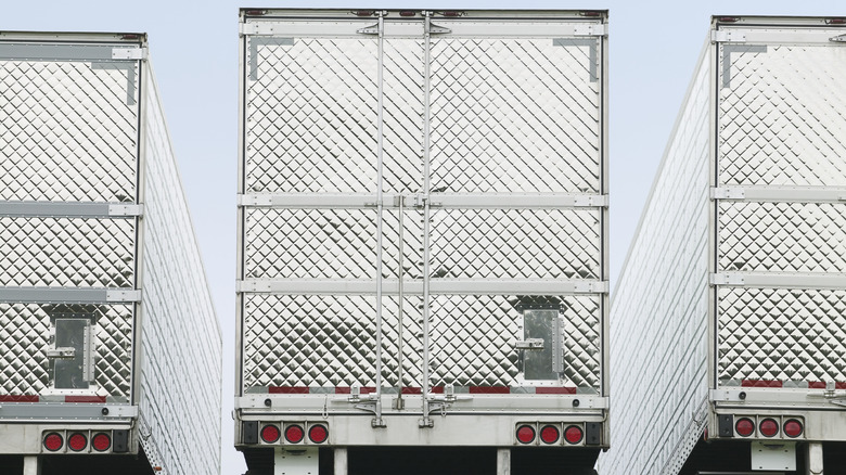 back doors with diamond pattern on three semi-trucks