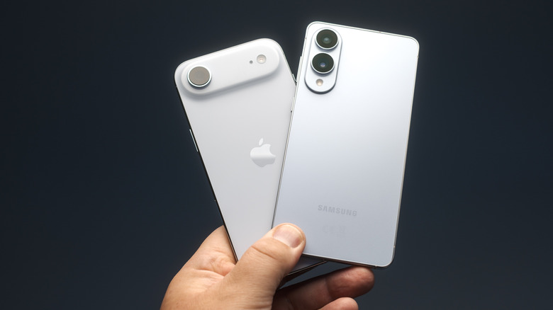 A person holding a Samsung Galaxy Edge and iPhone Air