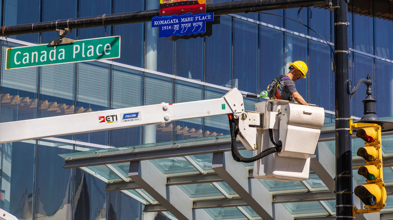 Man working on traffic light in Canada