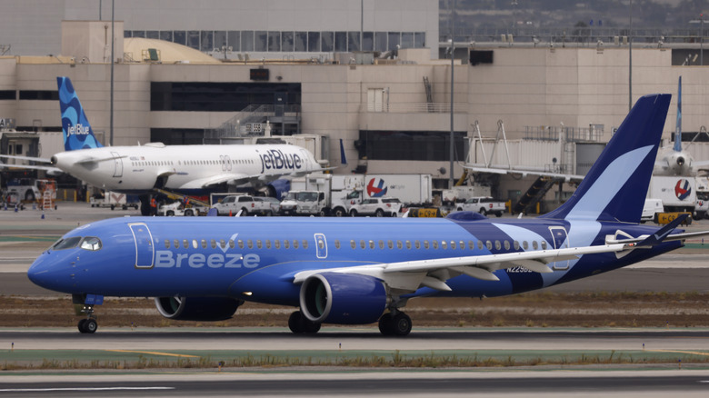 breeze and jetBlue airplanes on the runway