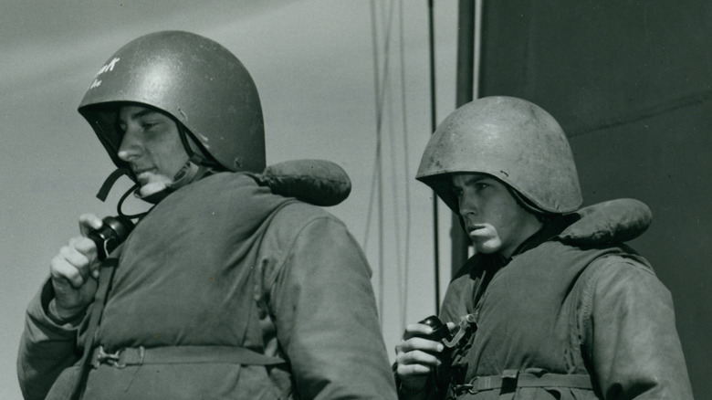 Navy soldiers wearing talker helmet.