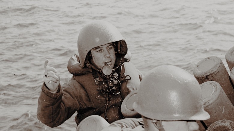 Navy radioman wearing talker helmet.