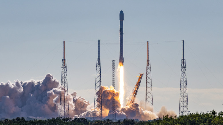 SpaceX Falcon 9 rocket and satellite payload launching into space