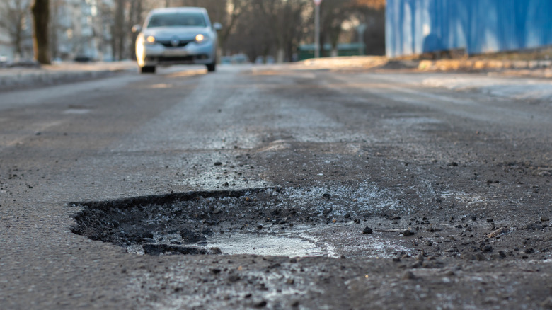 A pothole forming on a road.