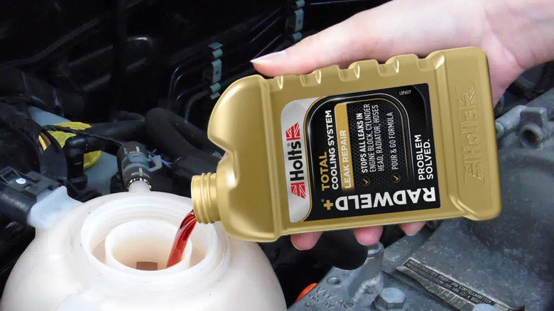 Person pouring Radweld stop-leak into their car