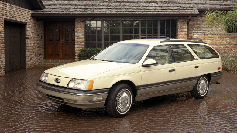 Yellow Ford Taurus in driveway