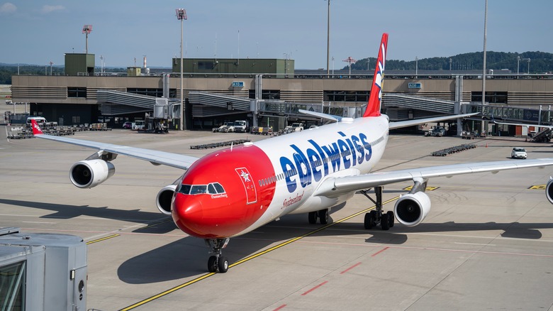 White and red Edelweiss Air Airbus A340 at ZRH international airport on a sunny day