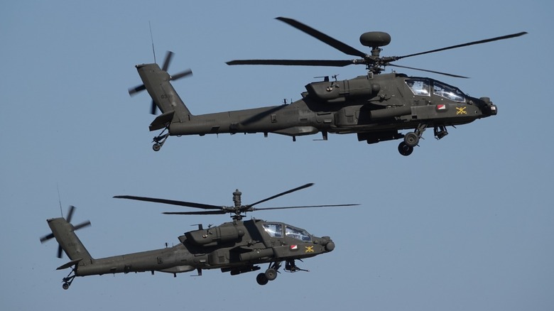 Two Apache attack helicopters flying in formation