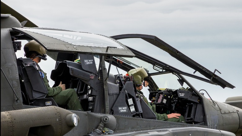 Pilot and gunner sitting inside an AH-64 attack helicopter