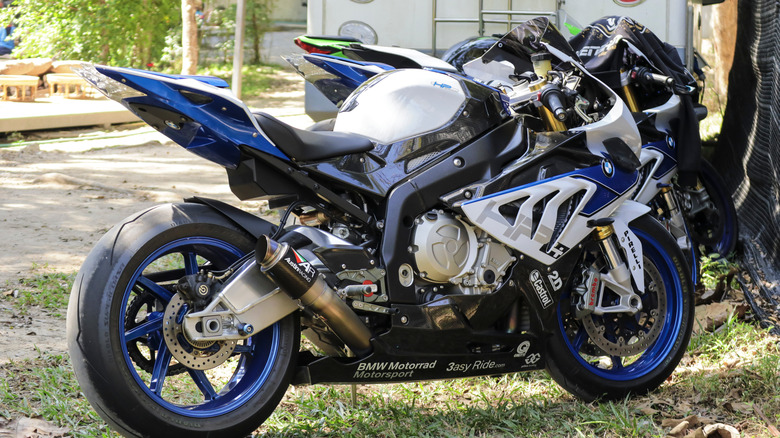 The BMW HP4 motorcycle parked under the tree in coffee shop at Chiangmai, Thailand