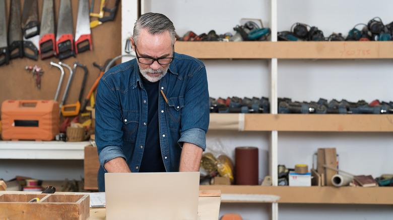A carpenter working on laptop