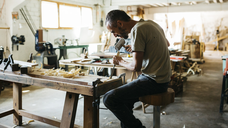 Carpenter sitting on chair and working
