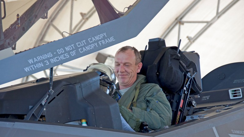 A pilot smiling inside the cockpit of an F-35A Lightning II