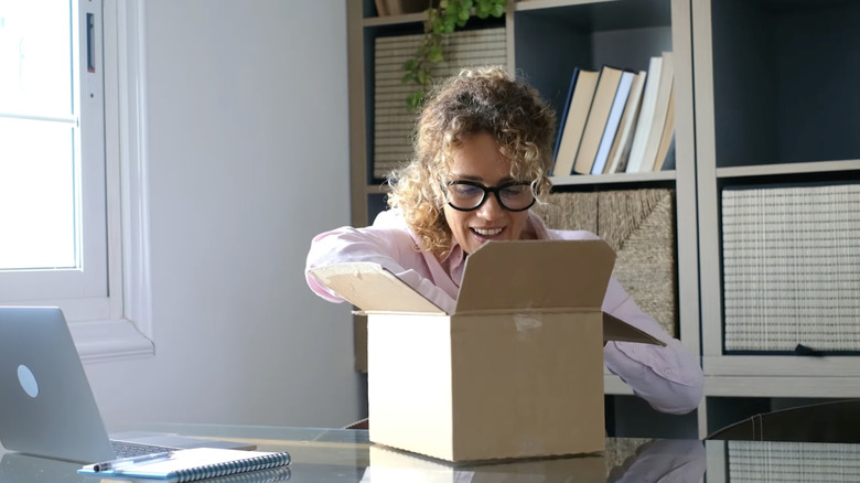 a woman opens a suspicious unlabeled package
