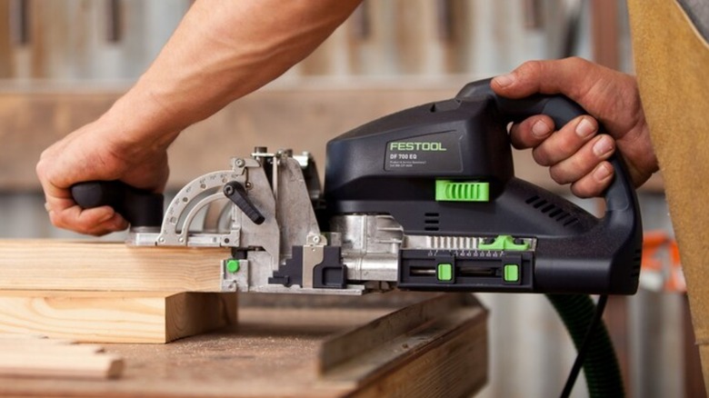 Person using Festool Domino Joiner on wood board