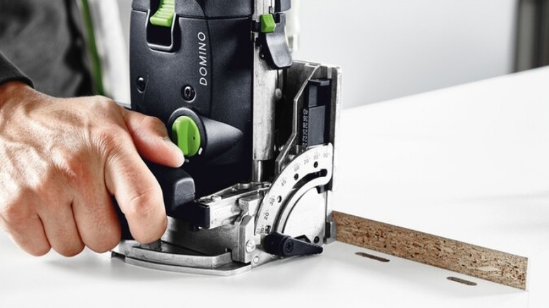 Person using a Festool Domino Joiner on particle board