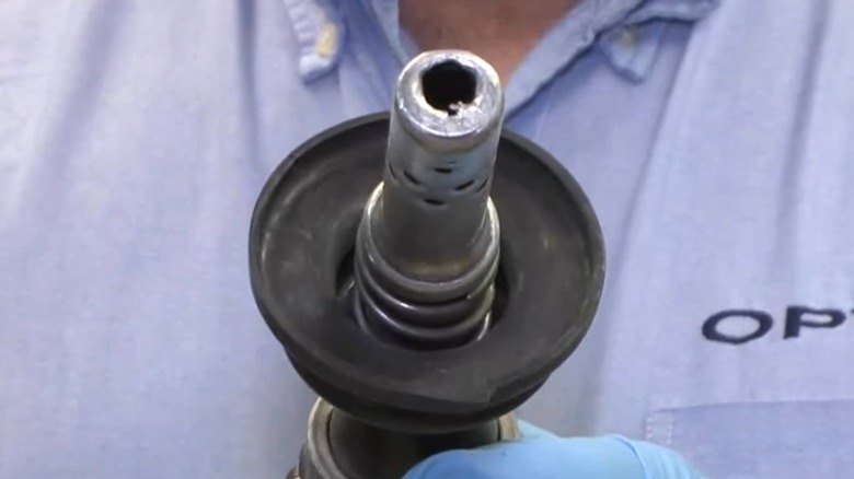 A damaged fuel pump nozzle spout tip