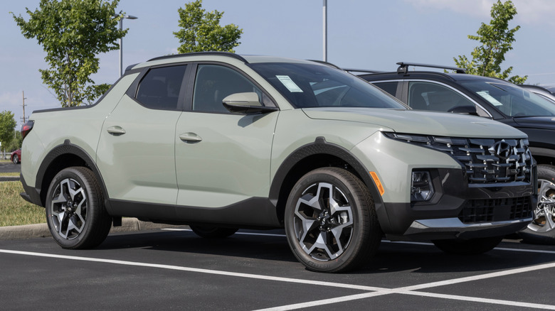 A light green Hyundai Santa Cruz in a parking lot.