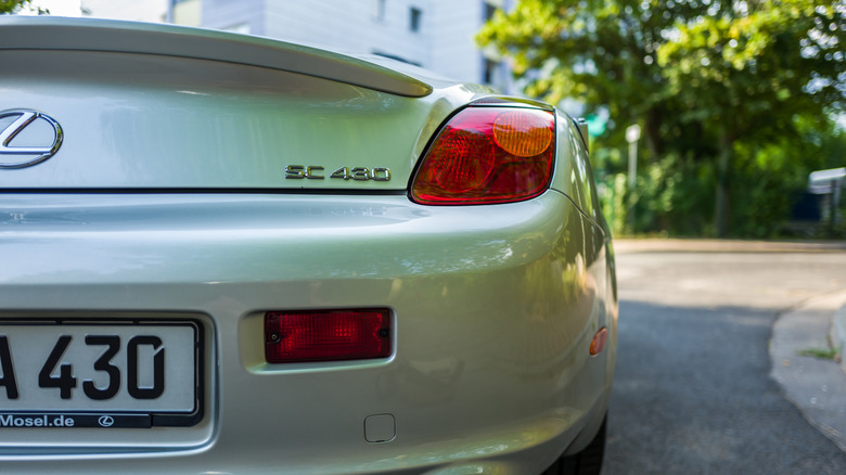 The rear end of a silver Lexus SC430