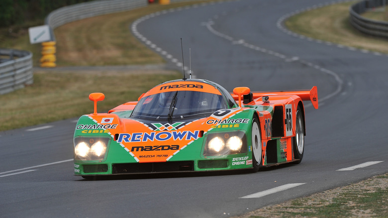 Front 3/4 view of the 1991 Mazda 787B on the Le Mans circuit