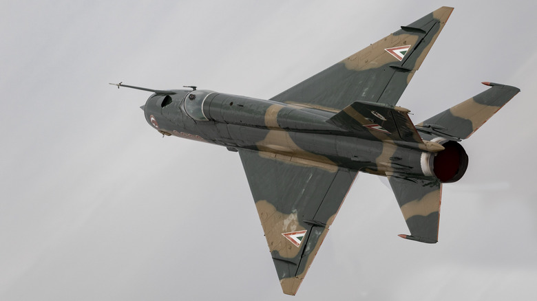 Mikoyan-Gurevich MiG-21 Fishbed flying on an overcast backdrop