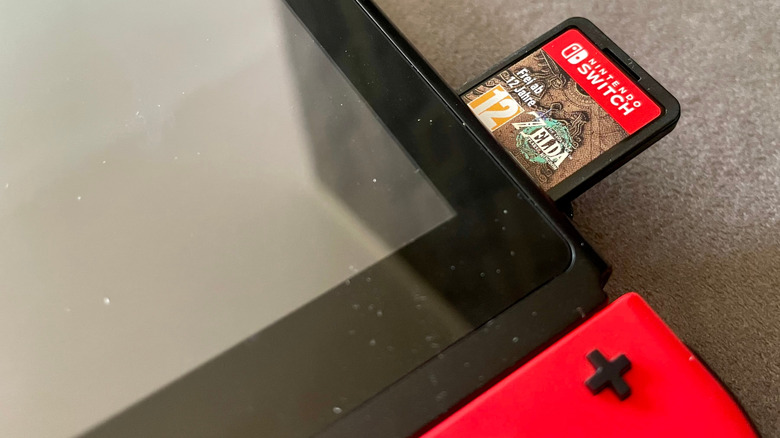 A Nintendo Switch with a cartridge partially installed
