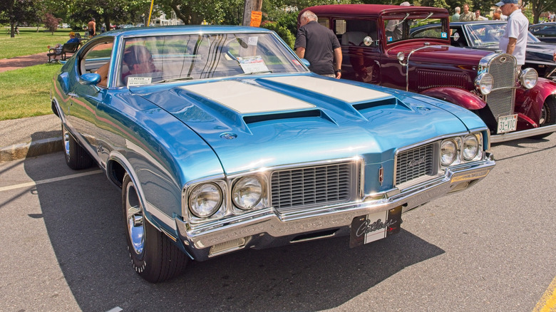 W-31 equipped 1970 Oldsmobile Cutlass with hood scoops, blue with white stripes, front 3/4 view