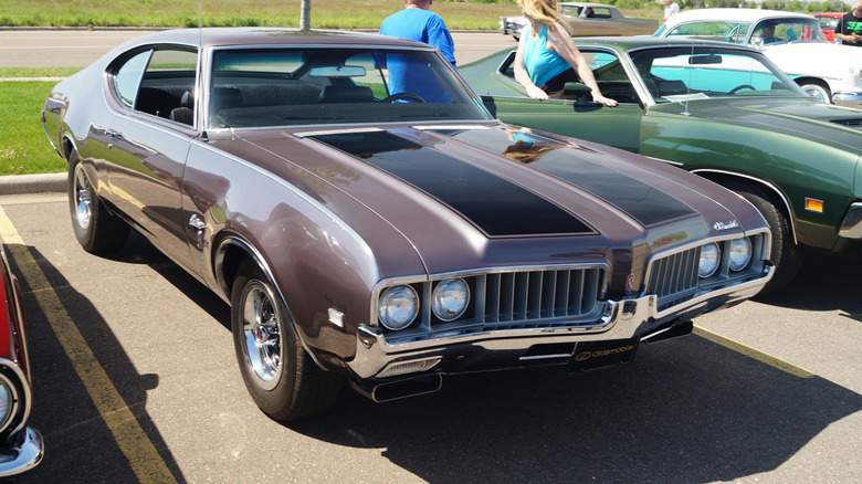 W-31-equipped 1969 Oldsmobile Cutlass, front 3/4 view, brown exterior, muscle car show