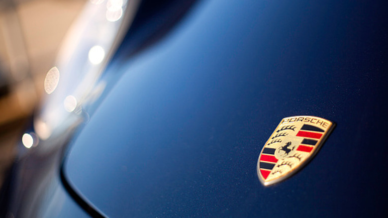Porsche logo on blue car