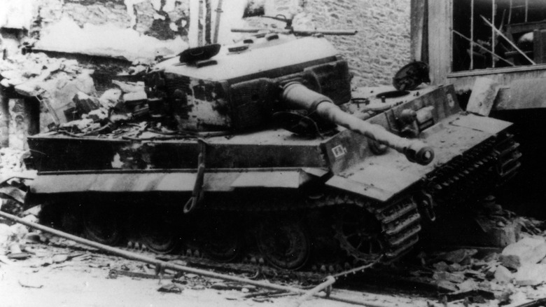 A wrecked Tiger I German tank along the roadside during World War II.