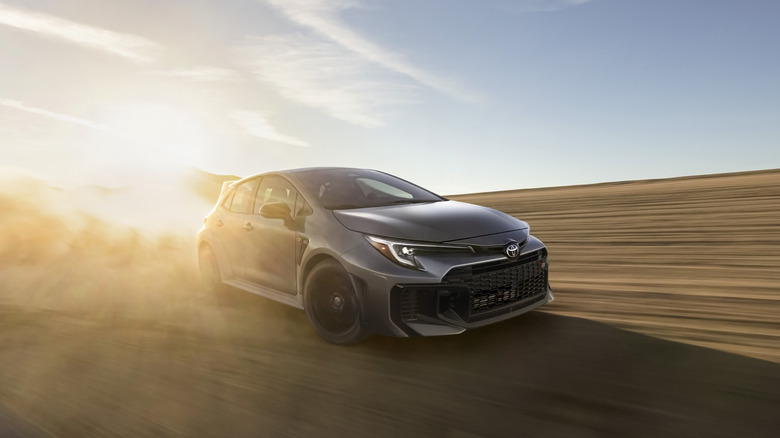 Toyota GR Corolla drifting through the desert, front 3/4 view