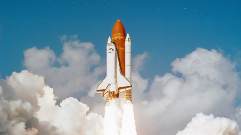 A space shuttle flying into space.