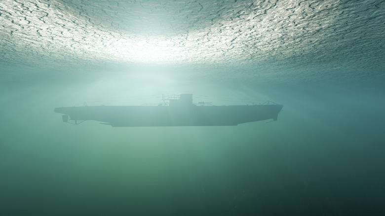 side view of a submarine sailing under the green water