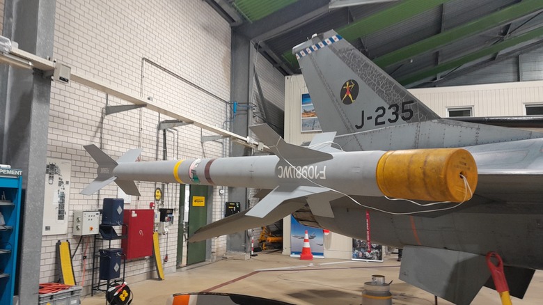 Sidewinder missile mounted on aircraft inside hangar