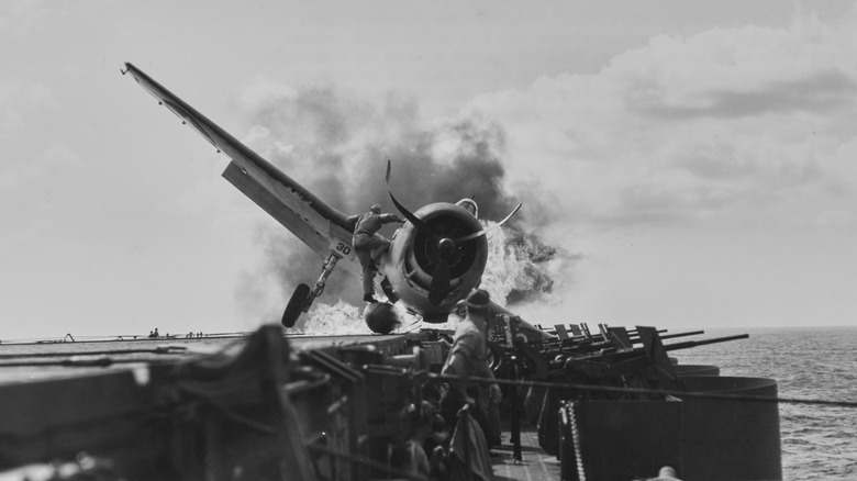 Burning F6F Hellcat on deck of USS Enterprise during World War II