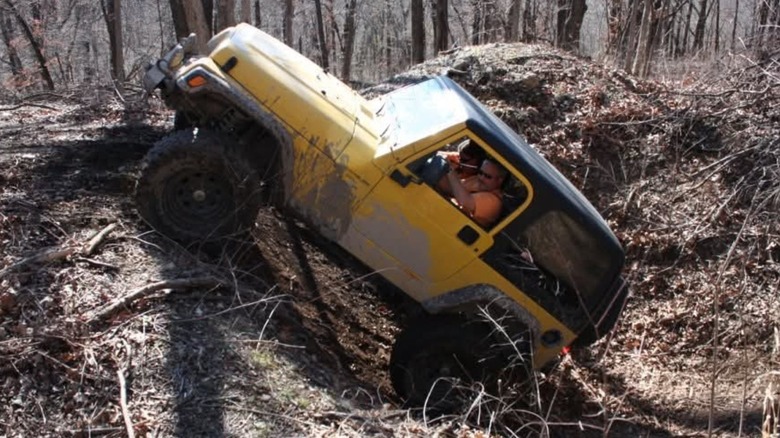The author's lifted 2000 Jeep Wrangler Sport climbing out of a hole.